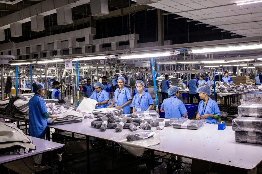 Workers in a factory sort and package items.