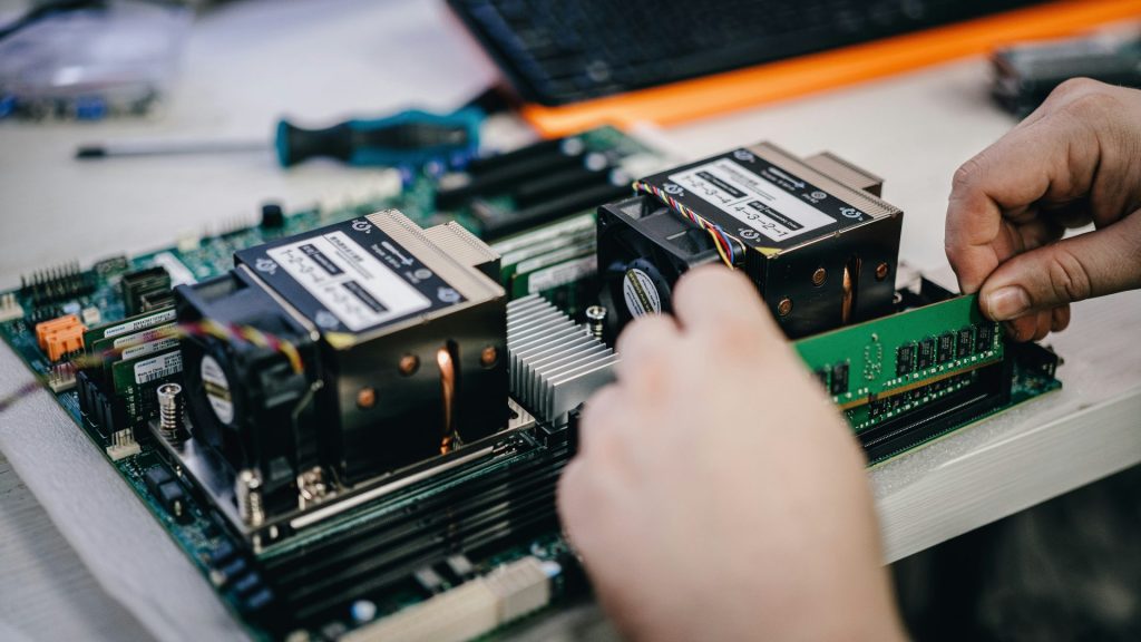 A person working on a computer motherboard